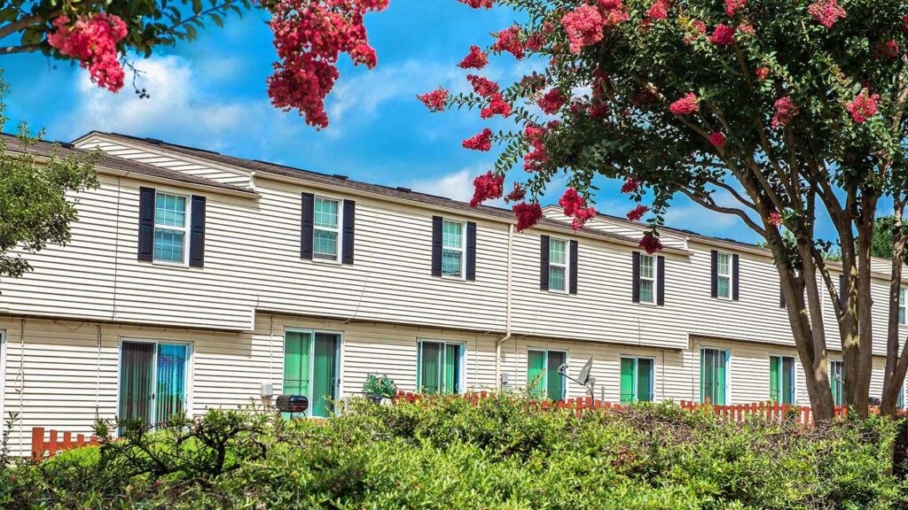 Exterior of Hopkins Point townhomes with foliage