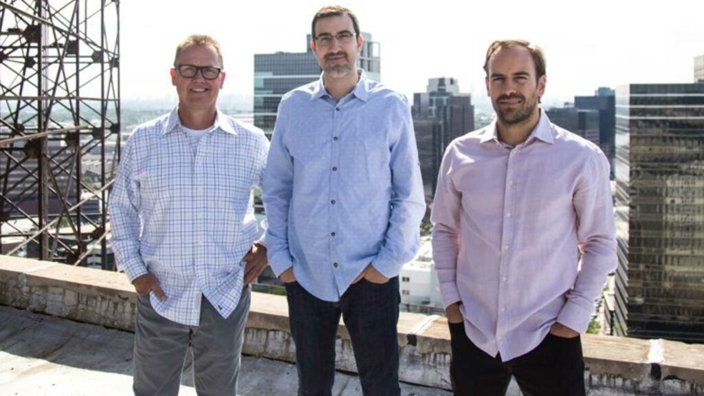 The founders of OneWall on a rooftop