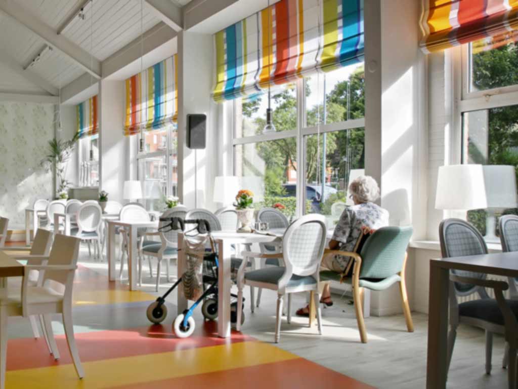 Woman sitting at a table at senior living facility