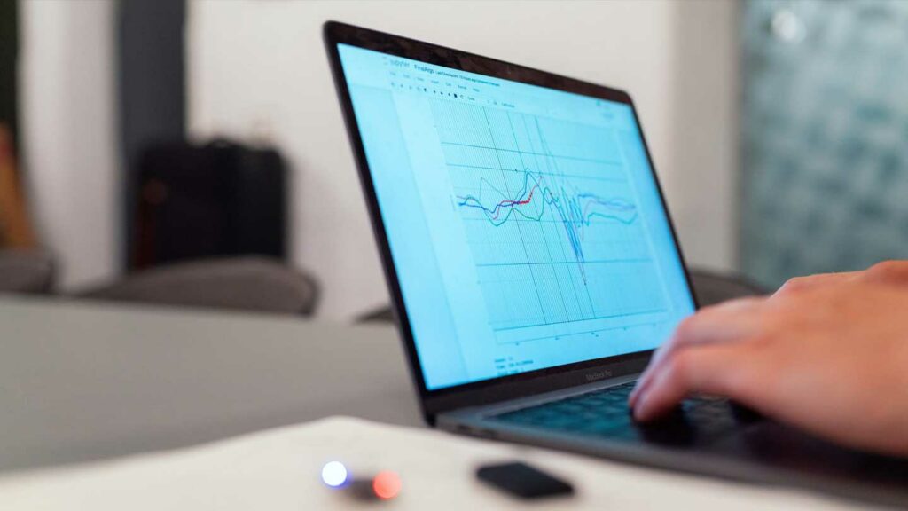 Person looking at a graph on a laptop